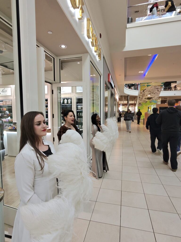 Luxury Roaming Atmosphere Performers | Elegant Guest Welcome Experience Vaudezilla Elegant roaming atmosphere performers greeting guests during luxury retail and corporate activation