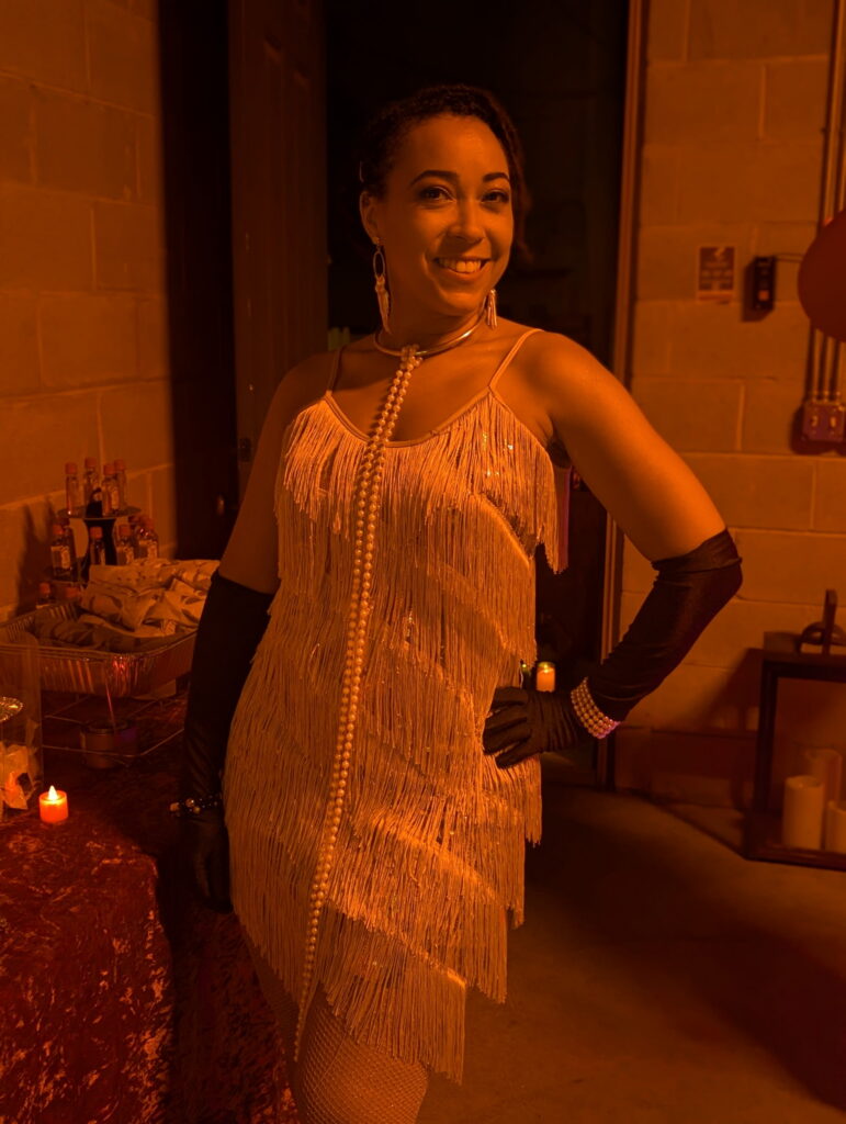 Elegant vintage inspired cabaret performer in gold fringe styling at immersive Chicago corporate cocktail event