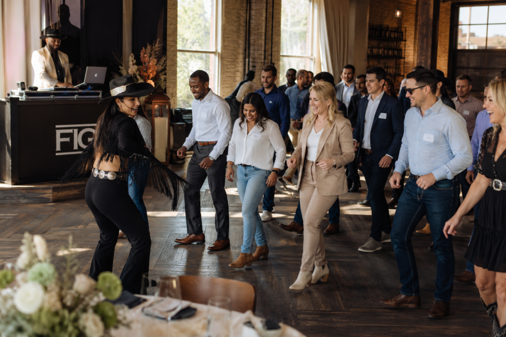 Luxury Corporate Western Activation with Interactive Line Dancing Vaudezilla Diverse corporate guests participating in an elevated western themed interactive dance experience during a luxury luncheon event
