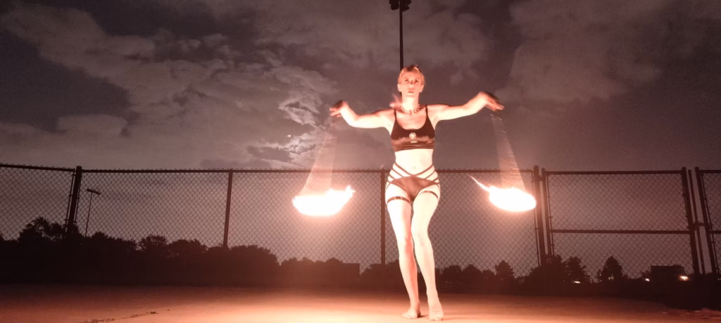 Corporate Fire Entertainment Chicago Vaudezilla Professional fire dancers performing an outdoor fire show for a Chicago corporate event at sunset