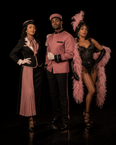 Pink Hotel Immersive Characters Vaudezilla Hotel hostess pink uniformed bellhop and cabaret showgirl posing together
