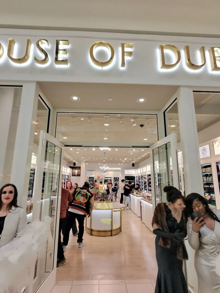 Guests browsing inside a brightly lit fragrance boutique during a Curatrix retail activation