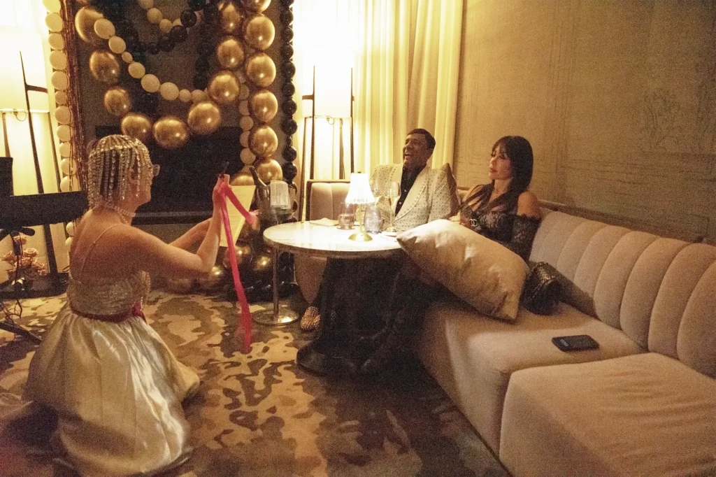 Personalized Birthday Finale at The Peninsula Chicago | Vaudezilla Vaudezilla Beaded Vaudezilla performer kneeling with a pink ribbon during a personalized birthday finale at The Peninsula Chicago