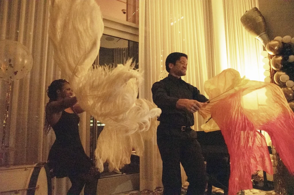 Feather Fan Performance at The Peninsula Chicago | Vaudezilla Vaudezilla Two Vaudezilla performers posing with large black feather fans at a private event at The Peninsula Chicago